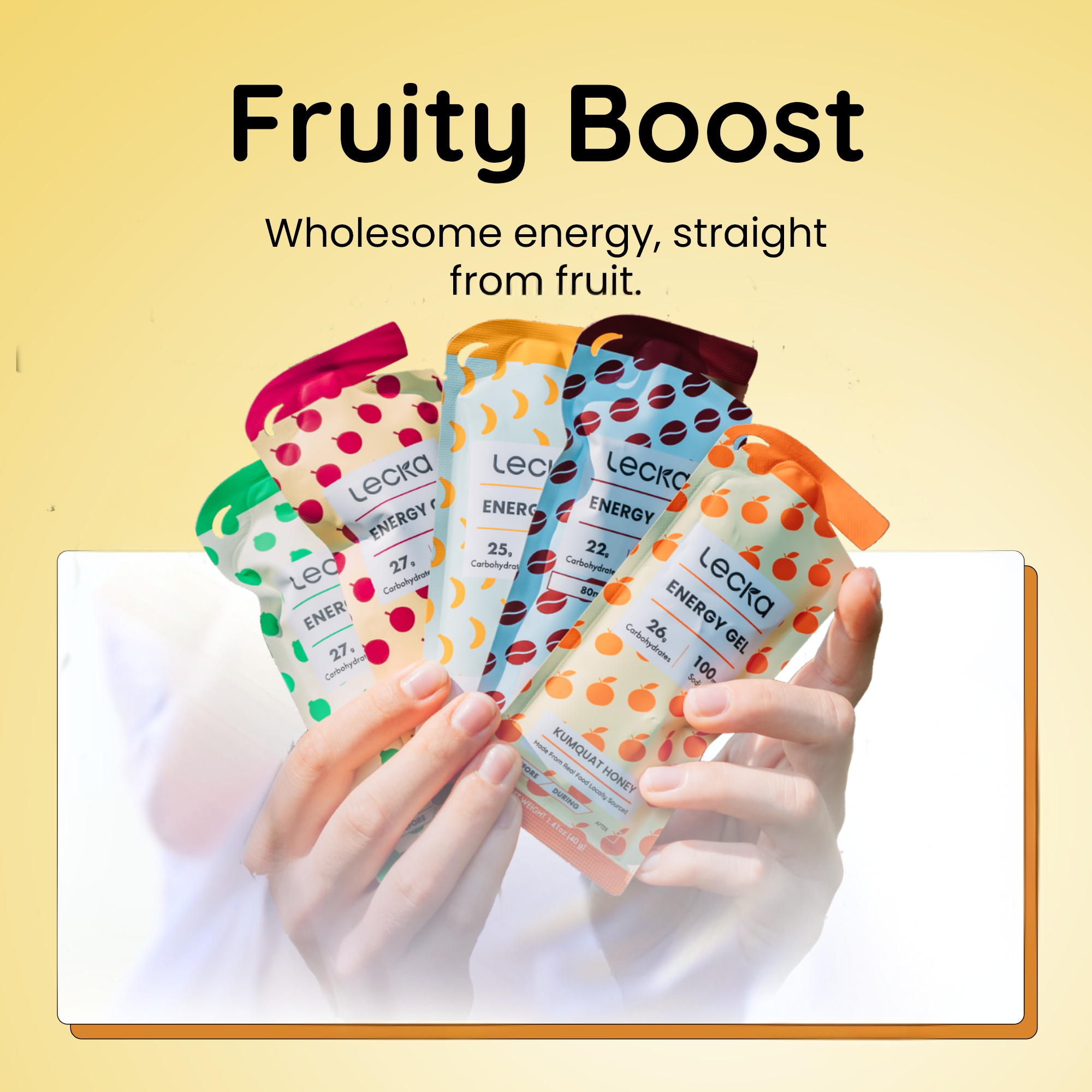 Hand holding Lecka Energy Gel packets with 'Fruity Boost' text on a yellow background