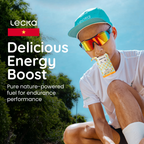 Person wearing sunglasses and a cap, sitting outdoors with Lecka energy boost packaging.