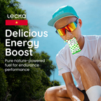 Person wearing sunglasses and a cap, sitting outdoors with Lecka energy boost packaging.