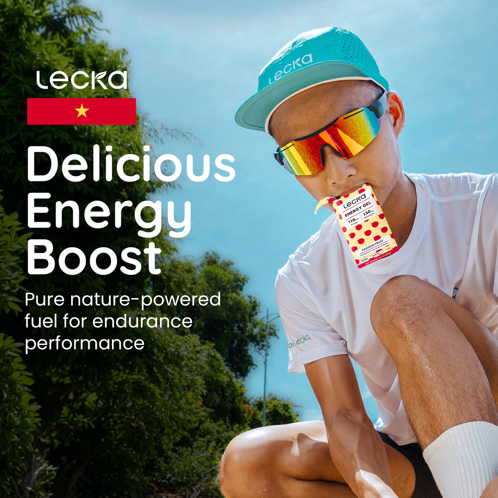 Person wearing sunglasses and a cap, sitting outdoors with Lecka energy boost packaging.