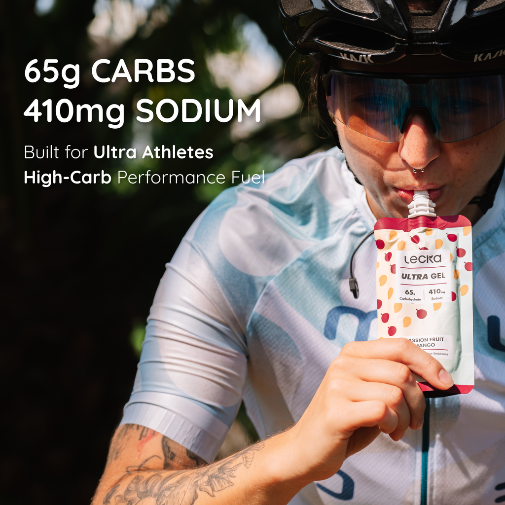 Person in cycling gear holding a Lecka Ultra Gel with nutritional information displayed. 65g carbs, 410mg sodium