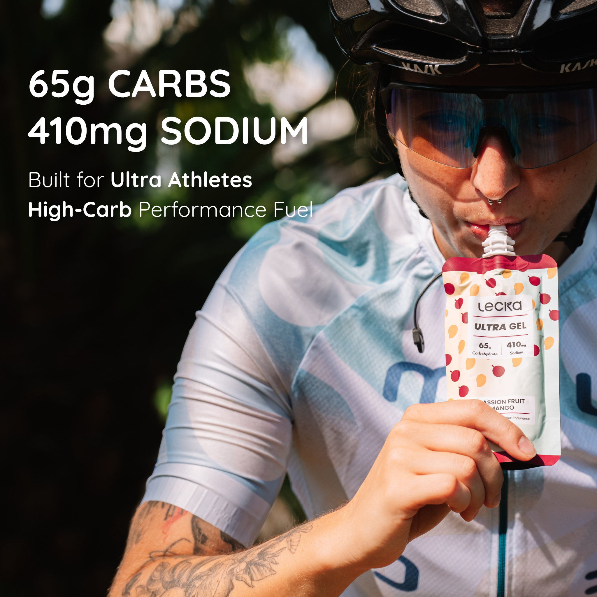 Person in cycling gear holding a Lecka Ultra Gel with nutritional information displayed. 65g carbs, 410mg sodium